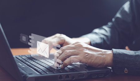 Businessman hands using Laptop typing on keyboard and surfing the internet on office table with...