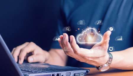 Cloud technology. Data storage. Networking and internet service concept.man use Laptop with cloud computing diagram show on hand.の写真素材