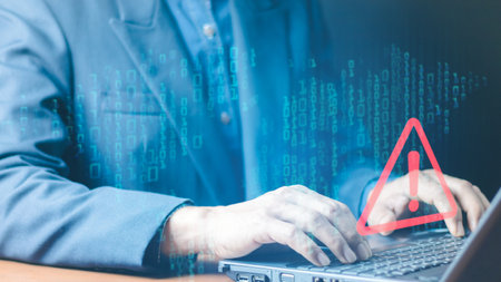 Error and maintenance concept. Businessman or it staff , programmer, developer using computer laptop with triangle caution warning sign for notification .の写真素材