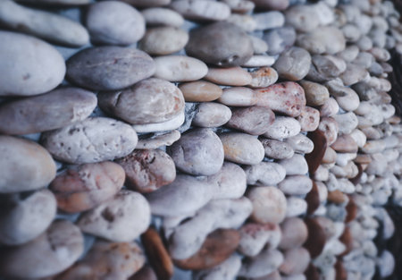 Small round stones background. Stone texture. Rough surface of small pebble stone.の写真素材