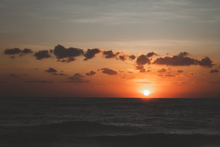 Beautiful cloudscape over tropical sea and beach shore, sunrise over ocean horizonの写真素材