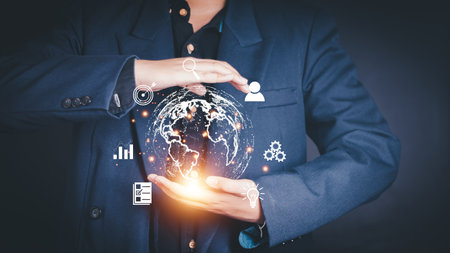 Businessman holding virtual world with icons and connection line for data exchange from globalization innovation technology and global business concept.の写真素材