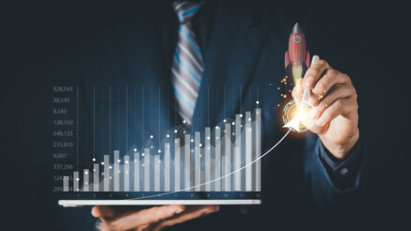 Businessman or merchant showing hologram stock with the direction of rising like a rocket in hand Finance concept, stock market, fast growing business like a rocket.の写真素材