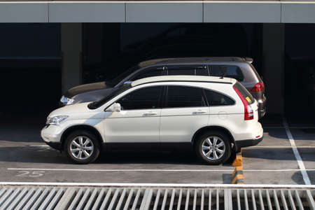 Cars in urban parking lot of high building(Bangkok Skyscraper).のeditorial素材