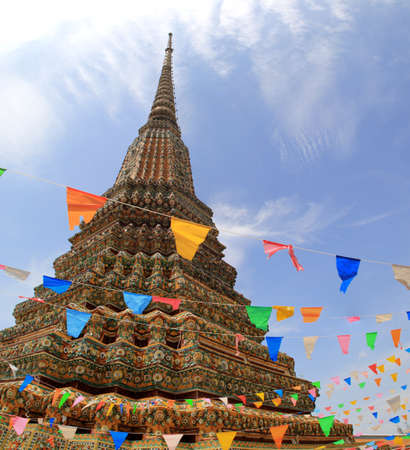 Every year in Thailand ,Colorful flags are decorated during Songran festival or Thai New year April 12-14 at The beautiful ancient mosaic pagoda over 200 yearsPho Templeのeditorial素材