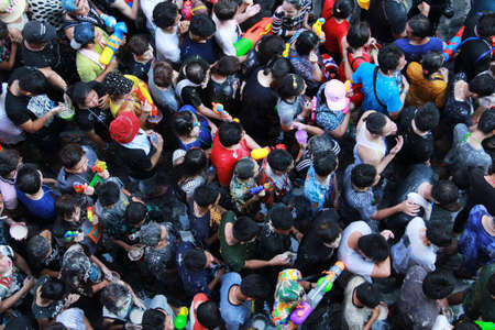 Bangkok, THAILAND - April  15,2016 :A lot of Foreign tourists and Thai people enjoy splashing water and put the natural white powder on their faces and mix with water during Songkran Festival on Silom Roadのeditorial素材