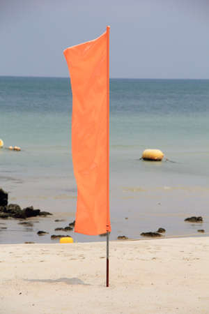 Play it Safe, Beach warning flag flapping in the wind, It is reccomended not to go in the water under red flag conditions.の写真素材