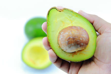 Fresh Avocado Halves On Handの写真素材
