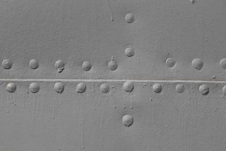 Military Silver metal plates background texture with seams and rivets. Riveted metal from Battleship.の写真素材