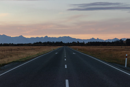 Open road with mountains at sunrise New Zealand sunset no people outside