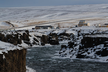 Coastal road winding through snowy hills