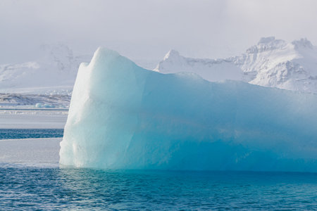 Iceberg with unique shape in calm blue waters
