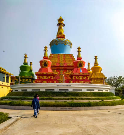 Bodh gaya Buddha temple in open light blue sky near some people looking itのeditorial素材
