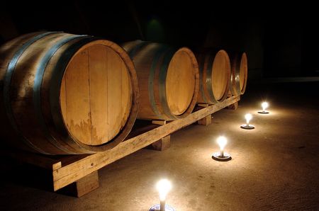Barrels of wine stocked in a wine cellar.