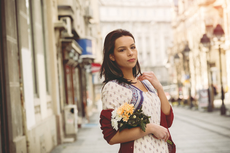 Girl with flowers on the boardwalkの写真素材