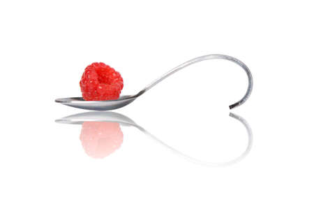 reberry on curved spoon with reflection make heart shape isolated on whiteの写真素材
