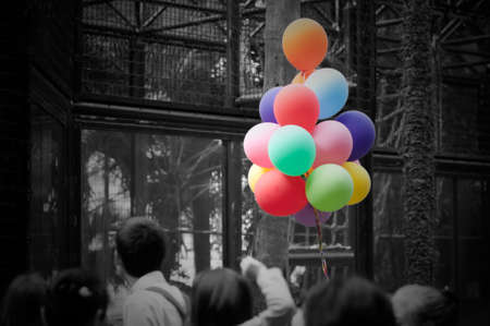 colorful ballons on black and white crowdの写真素材