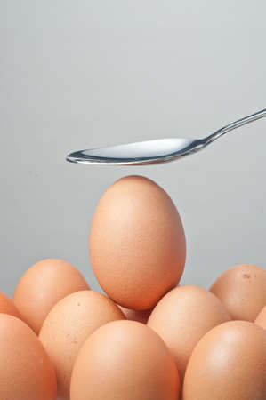 a special egg on a group of egg with a spoon above itの写真素材