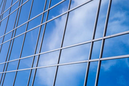 A clouds reflection in glass wall of skyscraperの写真素材