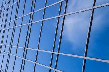 A clouds reflection in glass wall of skyscraperの写真素材