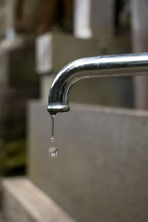 Faucet and water dropの写真素材