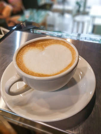 heart shaped latte art in white ceramic cupの写真素材