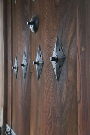 old wooden door with brass handles at Japanese templeの写真素材