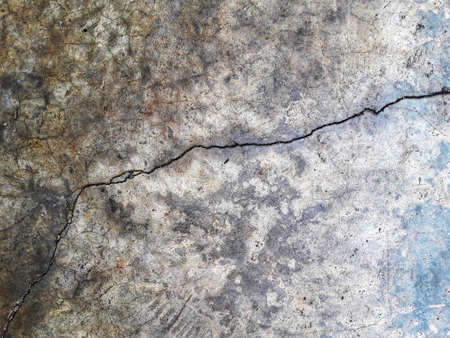THE CRACK ON THE WALL. Cracks on the surface of the cement wallの写真素材