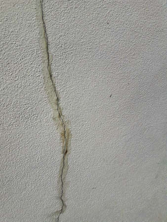 THE CRACK ON THE WALL. Cracks on the surface of the cement wallの写真素材
