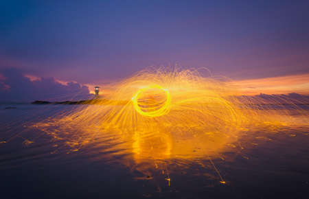 Activity time play steel wool at lighthouse sunset beautiful.の写真素材