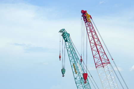 Crane lift green and red In the blue skyの写真素材