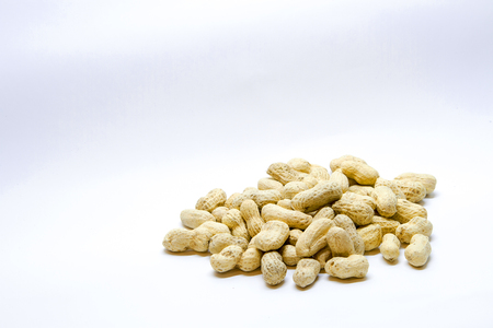 Many peanuts in the shell on a white backgroundの写真素材