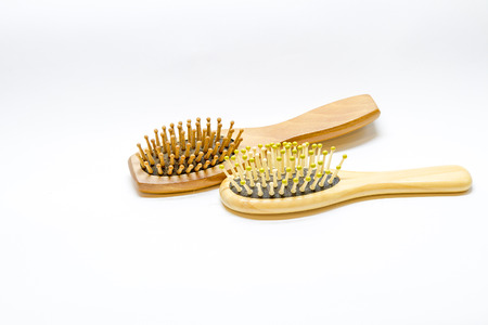 Hair brush comb with scraping hair on a white background.の写真素材