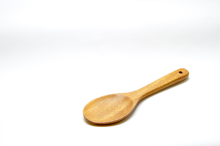 Brown wooden spoon on white backgroundの写真素材