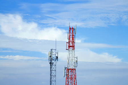 Mobile phone communication tower transmission  signal with blue sky background and antenna and twinの写真素材