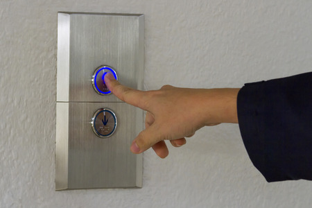 Using hands, press the elevator up and keypad elevator