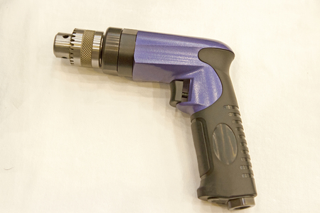 Purple Air Drill with black on the white table.の写真素材