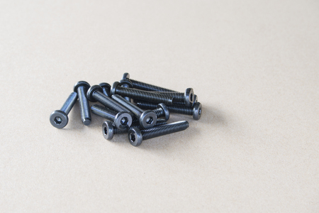 Socket button head of black  on brown background.