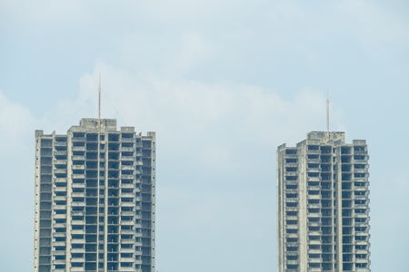 Two abandoned buildings with blue sky background.の写真素材