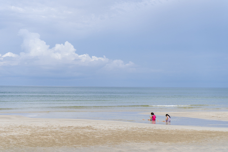 Children playing on the beach near the seaの写真素材