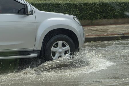 Truck driving through flood water on the roadの写真素材