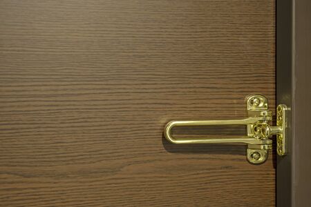 Golden door latch and wood grain backgroundの写真素材