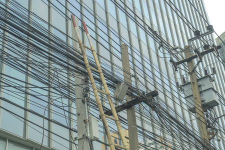 Bamboo stairs with light poles and busy wiresの写真素材