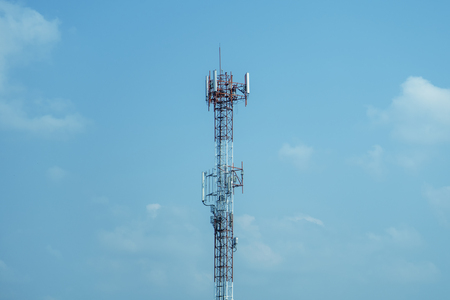 Mobile phone tower transmission  signal blue sky background and antennaの写真素材