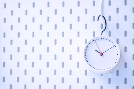 Closeup blue wall clock set on blue backgroundの写真素材