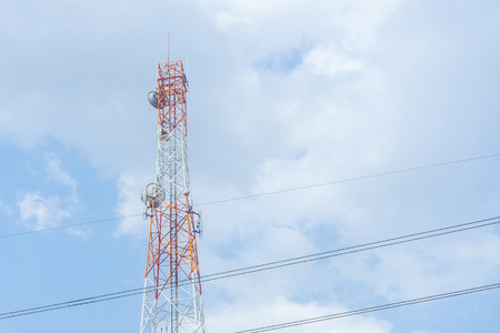 Mobile phone communication tower transmission blue sky backgroundの写真素材