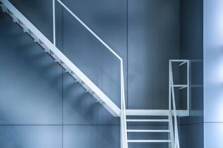 White iron staircase next to the buildingの写真素材