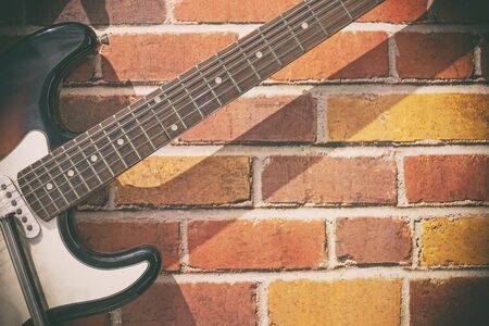 Guitar on a brick wall for life styleの写真素材