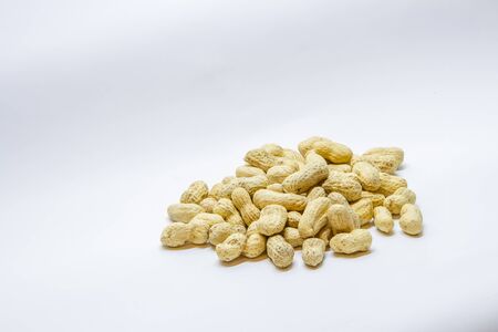 Many peanuts in the shell on a white backgroundの写真素材