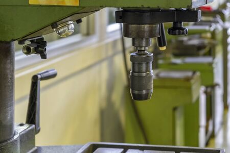 Machine workshop with drilling machine and old